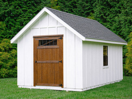 Cambridge Storage Shed set in backyard against trees.